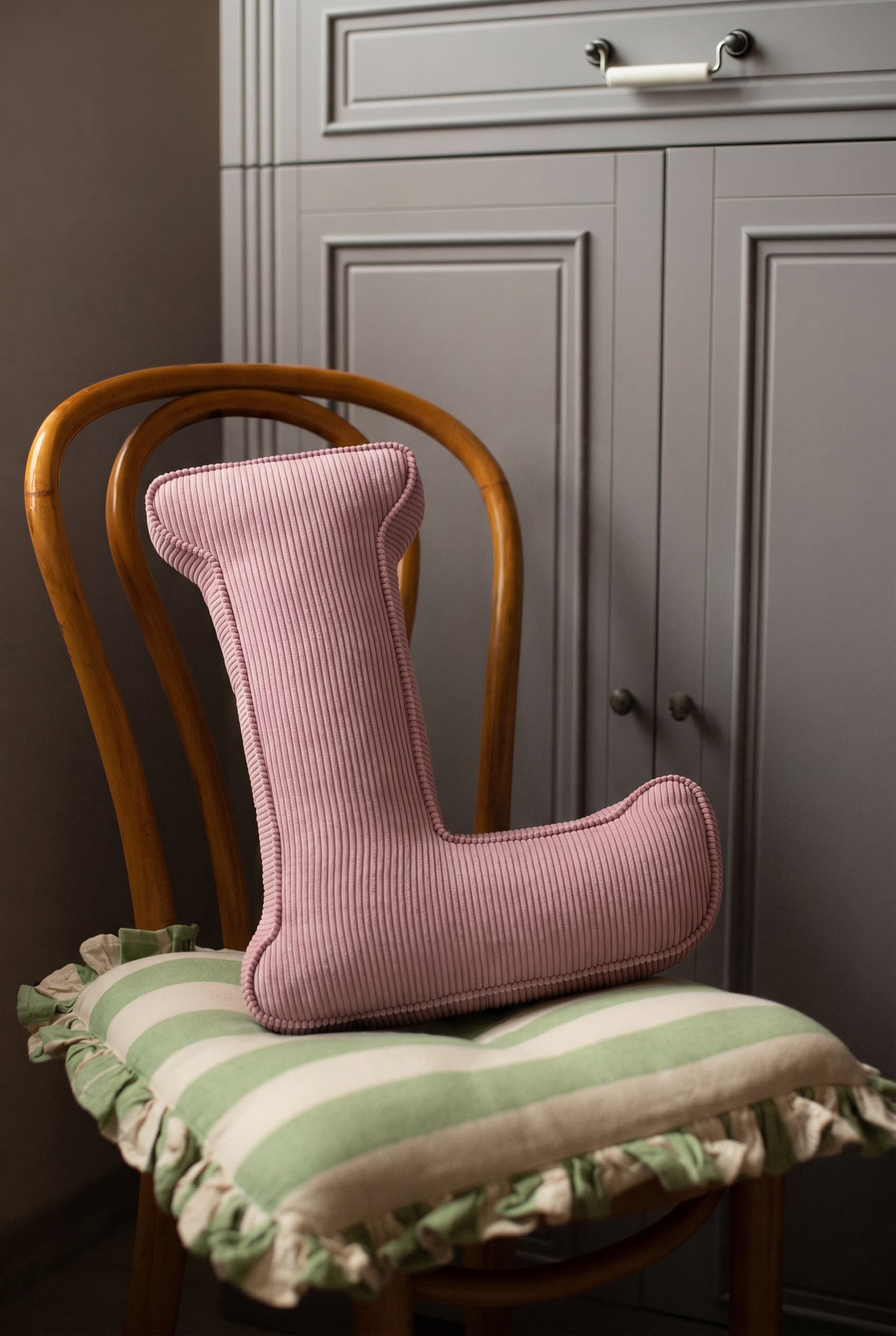 corduroy letter cushion L by bettys home in kids room on chair. Cushion in shape of letter
