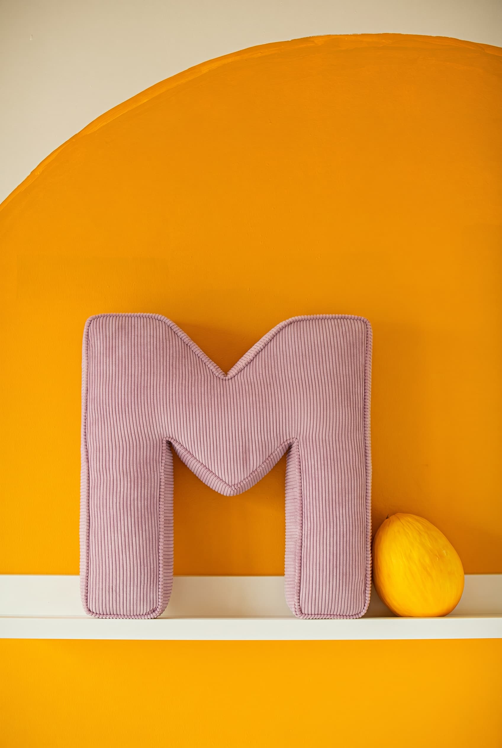 corduroy letter cushion M by bettys home in kids room on shelf. Cushion in shape of letter