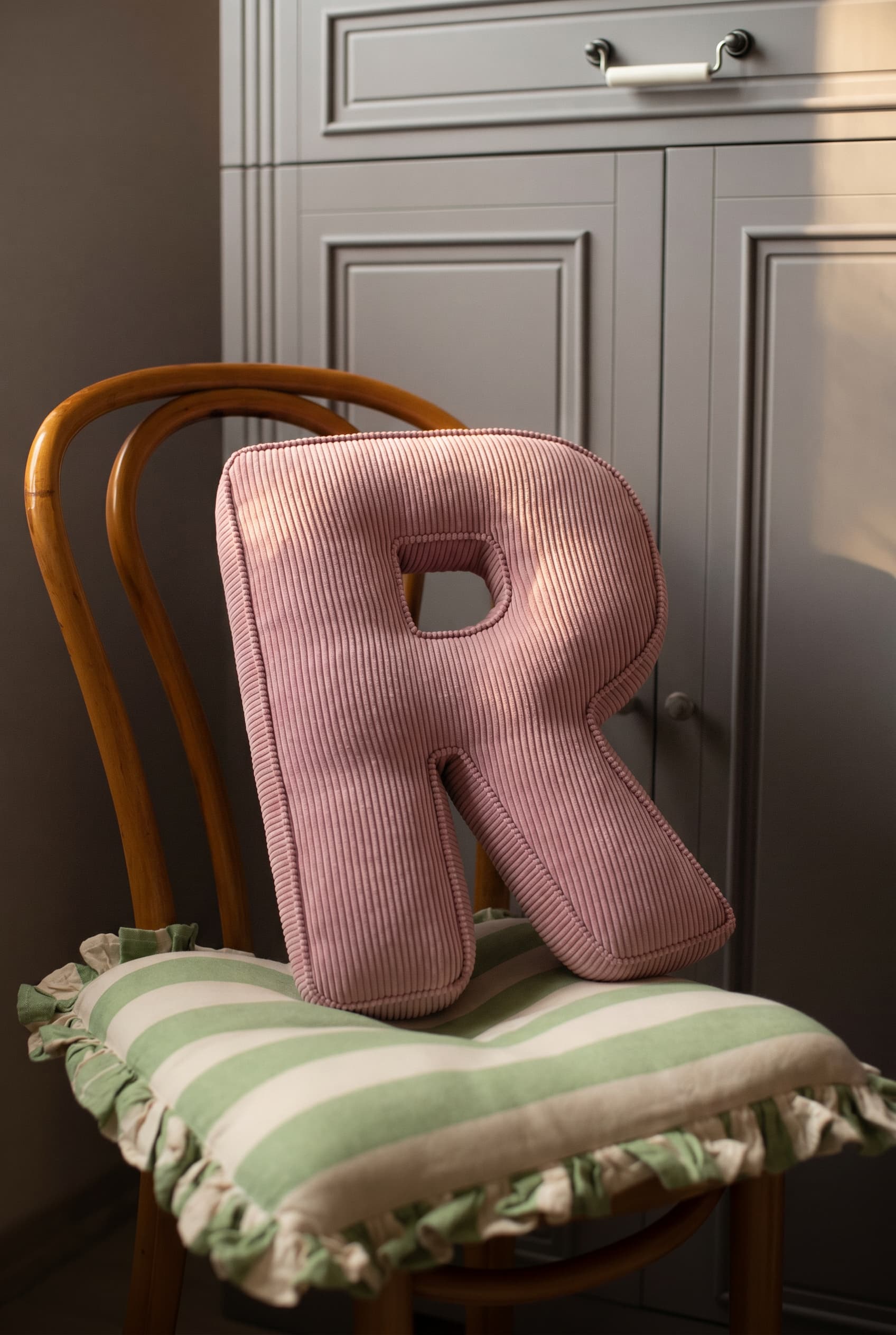 corduroy letter cushion R by bettys home in kids room on chair. Cushion in shape of letter