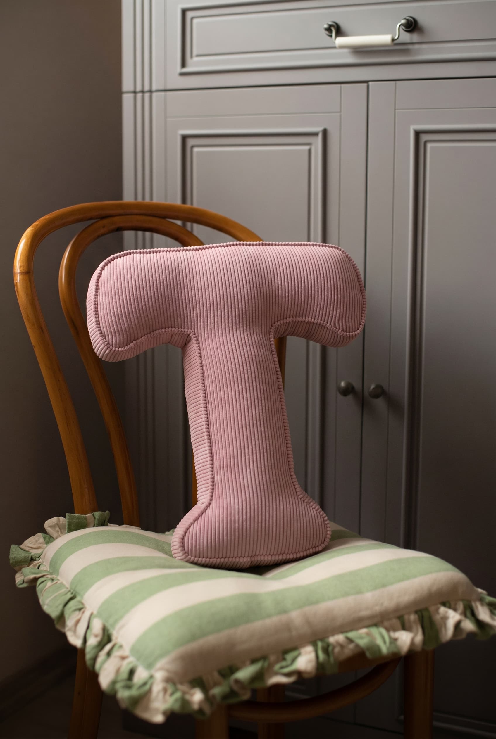corduroy letter cushion T by bettys home in kids room on chair. Cushion in shape of letter