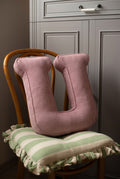corduroy letter cushion U by bettys home in kids room on chair. Cushion in shape of letter