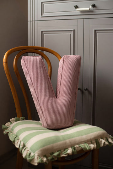 corduroy letter cushion V by bettys home in kids room on chair. Cushion in shape of letter
