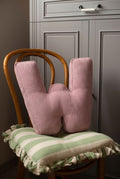 corduroy letter cushion W by bettys home in kids room on chair. Cushion in shape of letter