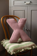 corduroy letter cushion X by bettys home in kids room on chair. Cushion in shape of letter