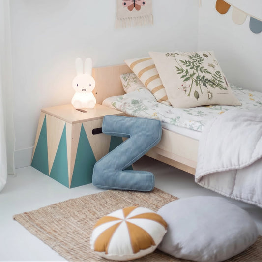 corduroy letter cushion Z by bettys home in kids room on floor next to bed. Cushion in shape of letter