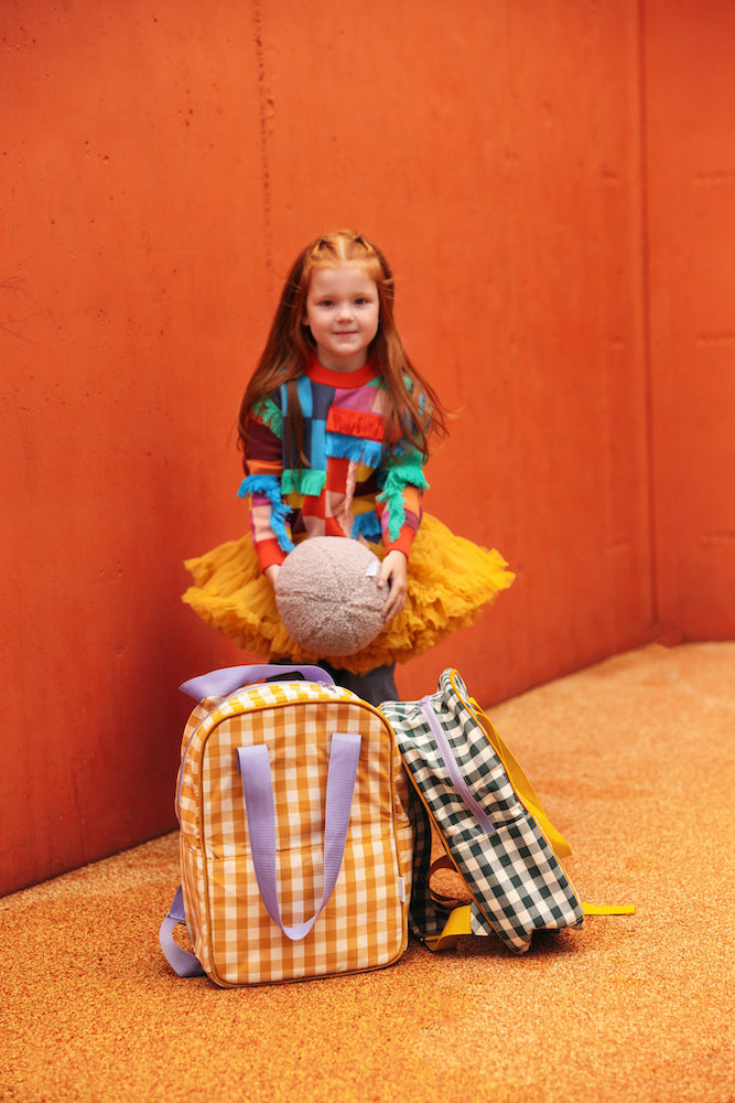 girl in playground standing behind gingham backpack in yellow boy bettys home. Gingham Backpack Sunflower