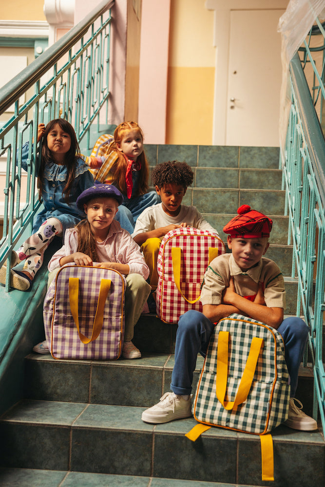 Children sitting on the steps at school after school with gingham backpacks by bettys home 