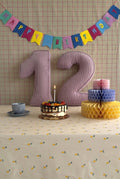 Corduroy Number Cushion by Bettys Home on birthday table with cake