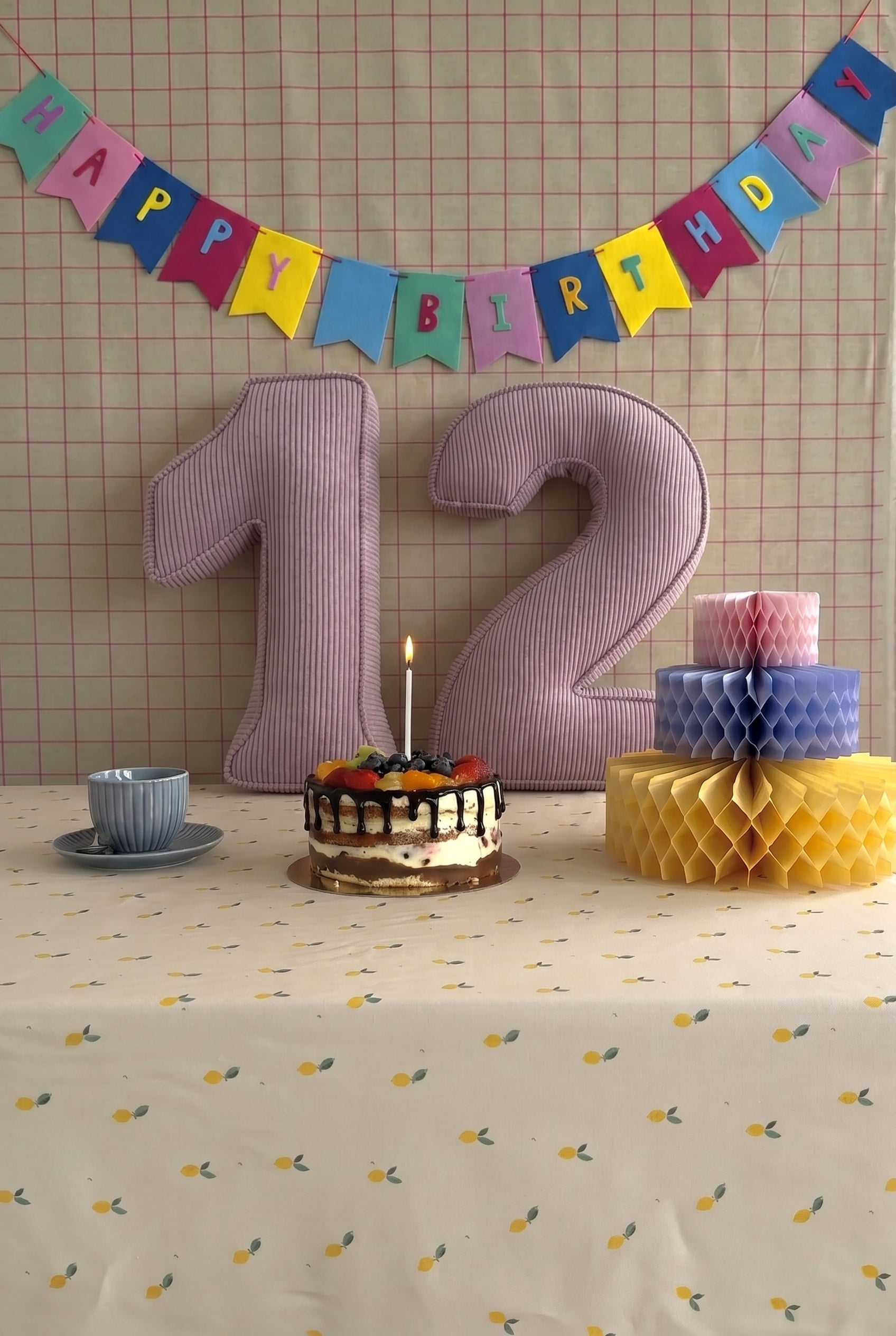 Corduroy Number Cushion by Bettys Home on birthday table with cake
