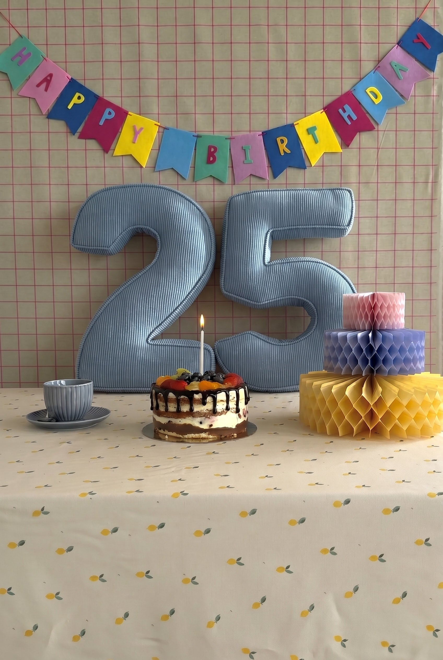 Corduroy Number Cushion by Bettys Home on birthday table with cake