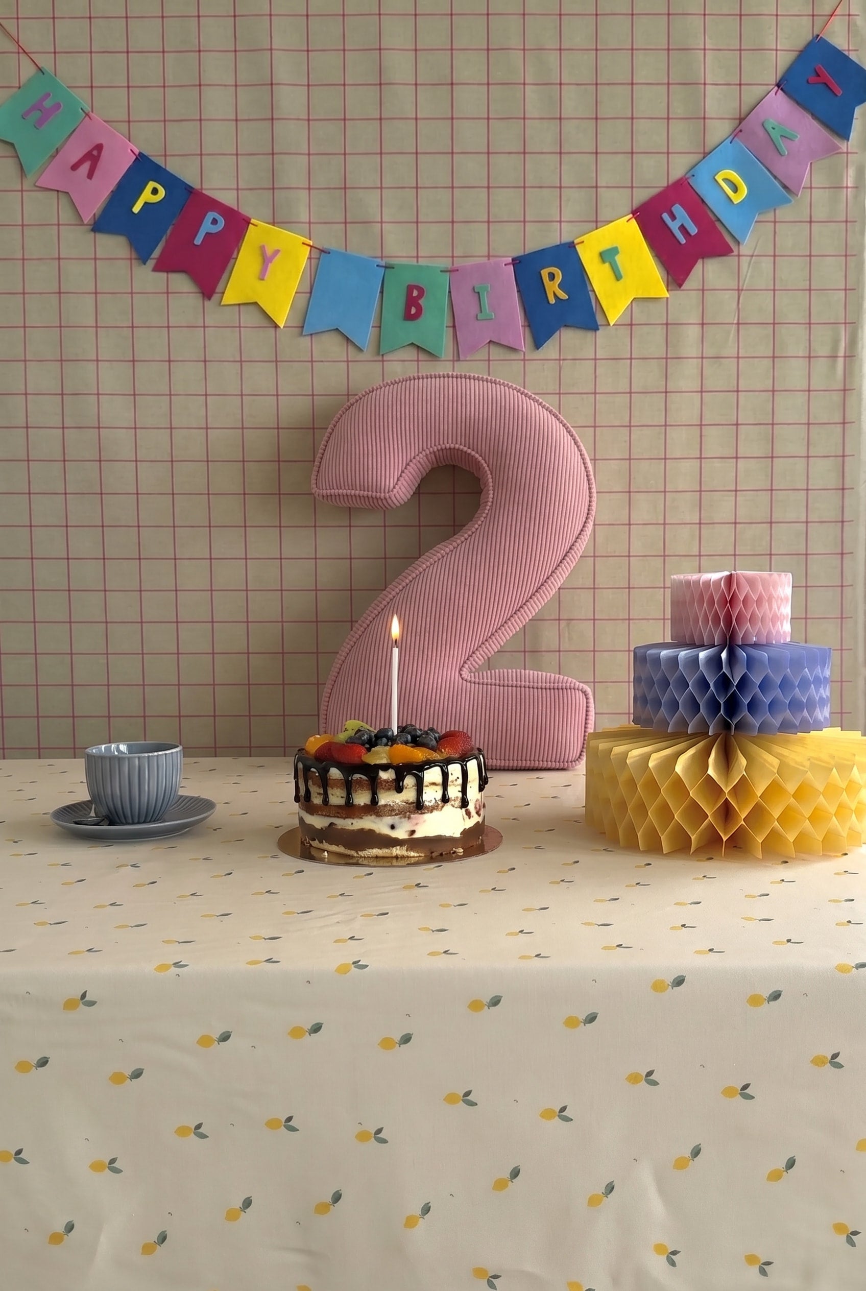 Corduroy Number Cushion by Bettys Home on birthday table with cake