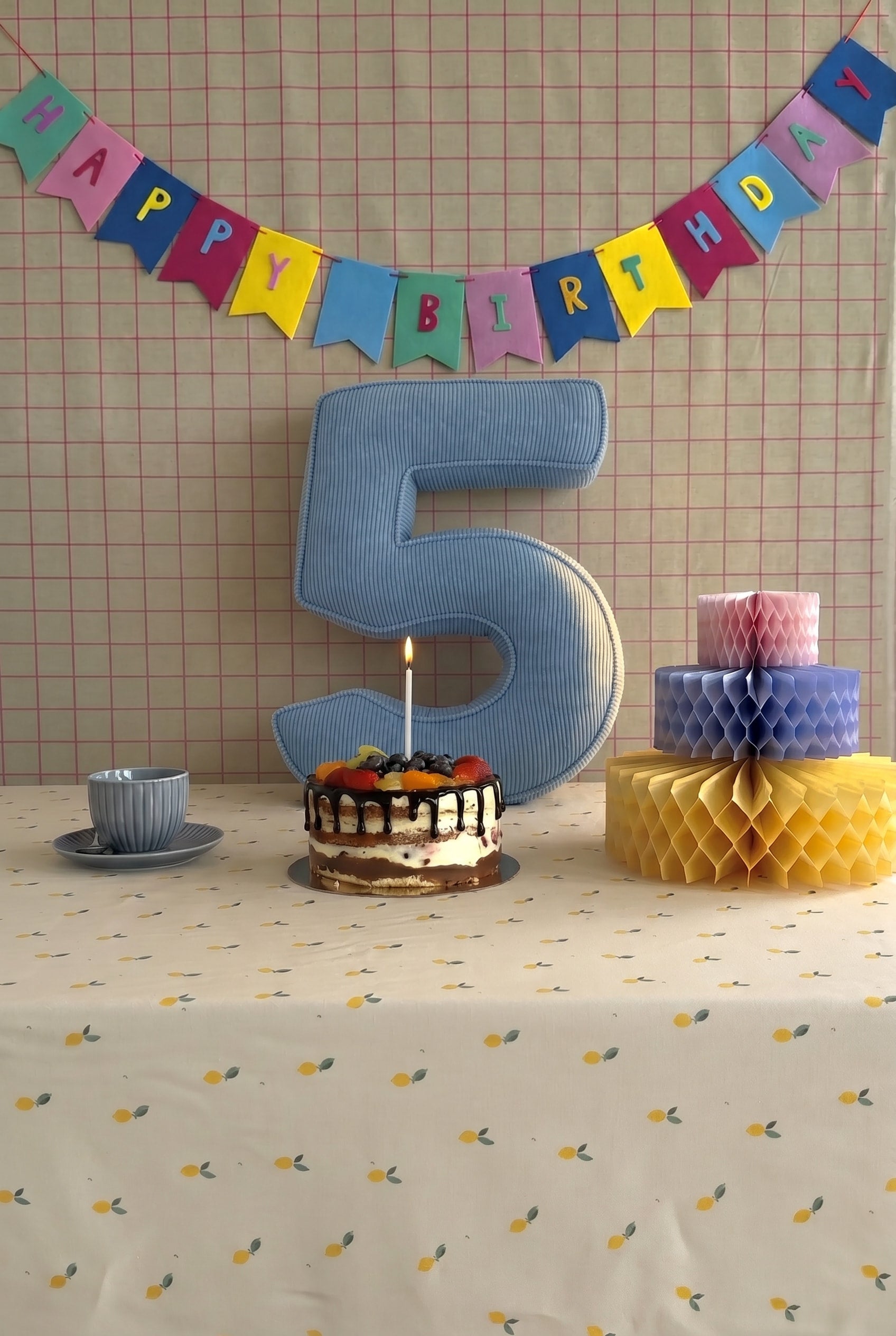 Corduroy Number Cushion by Bettys Home on birthday table with cake