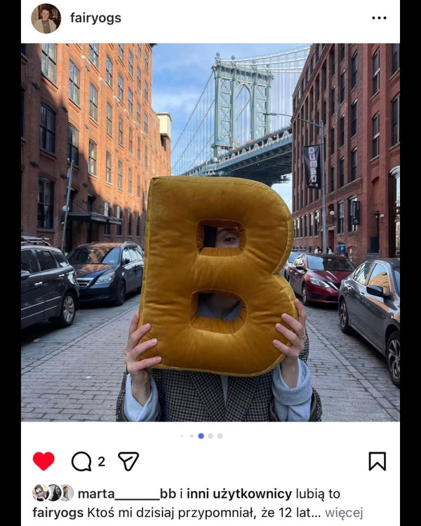 woman holding velvet letter cushion B by Bettys home on New York street