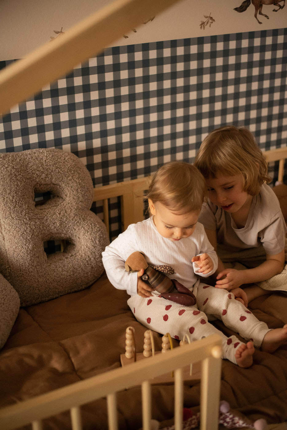 kids in crib next to boucle letter cushion B by bettys home. deco pillow kids gift idea. kids room decoration