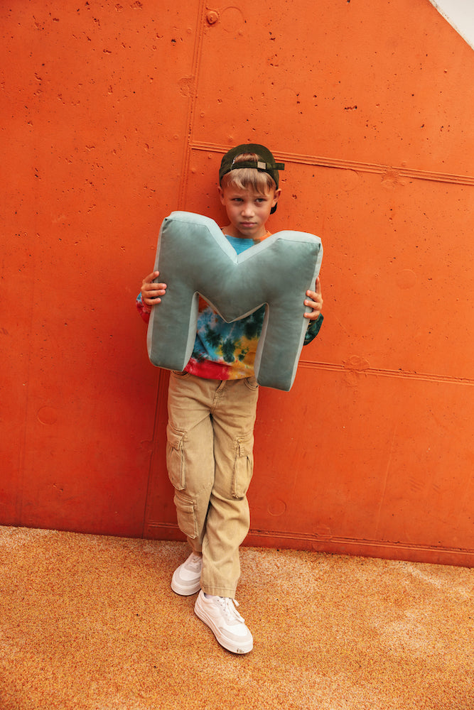 boy named MAX holding velvet letter cushions M by bettys home. Letter pillows velvet